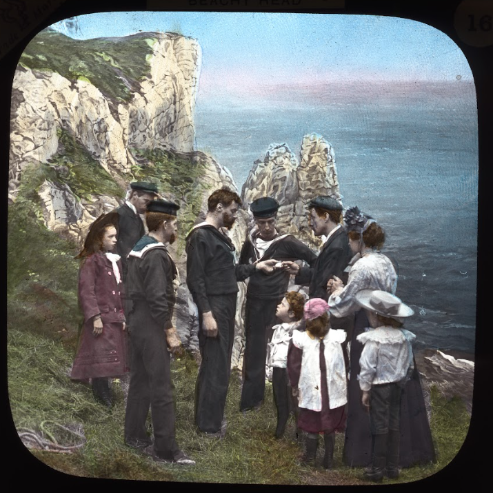 coastguard and civilians at top of cliff