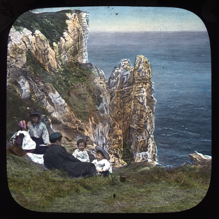 family sat on clifftop