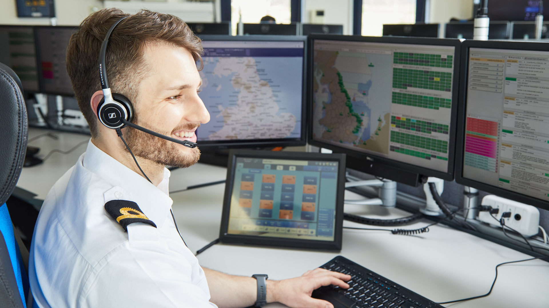 A HM Coastguard officer in a maritime rescue coordination centre