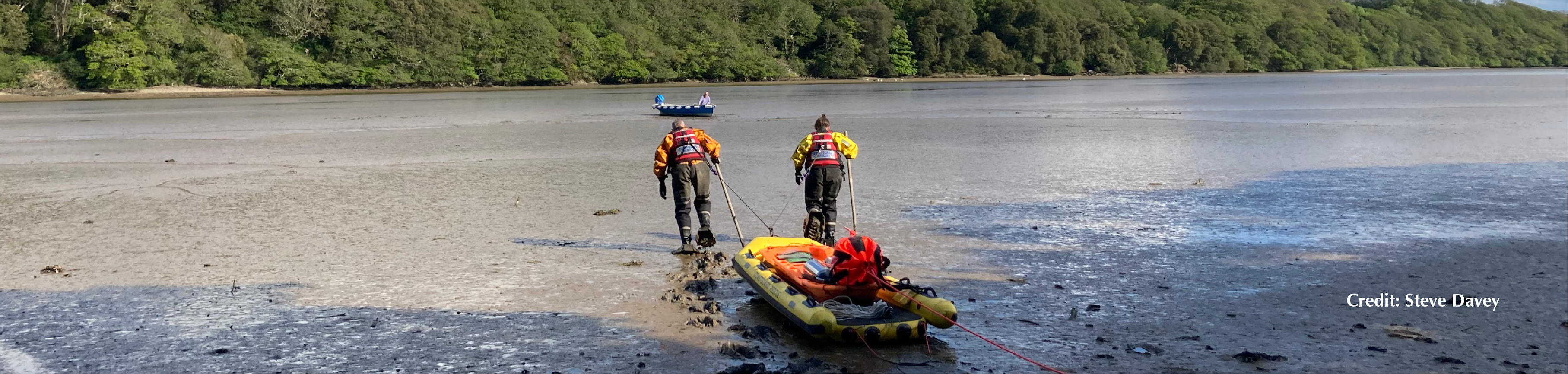 Two coastguard rescue officers on a mud rescue