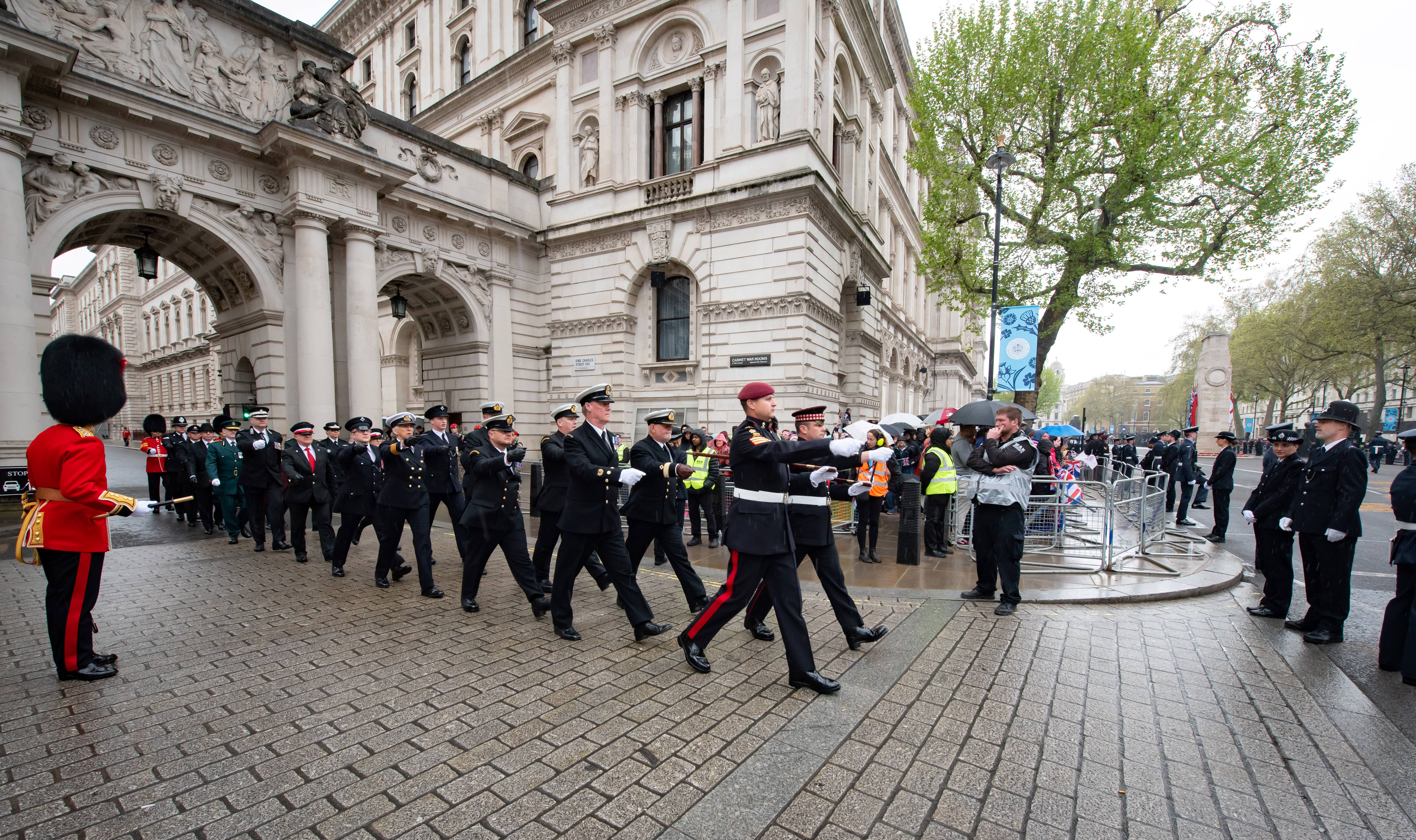 Uniformed members of the Civil Service Contingency marching through Westminster with The Cenotaph in the background