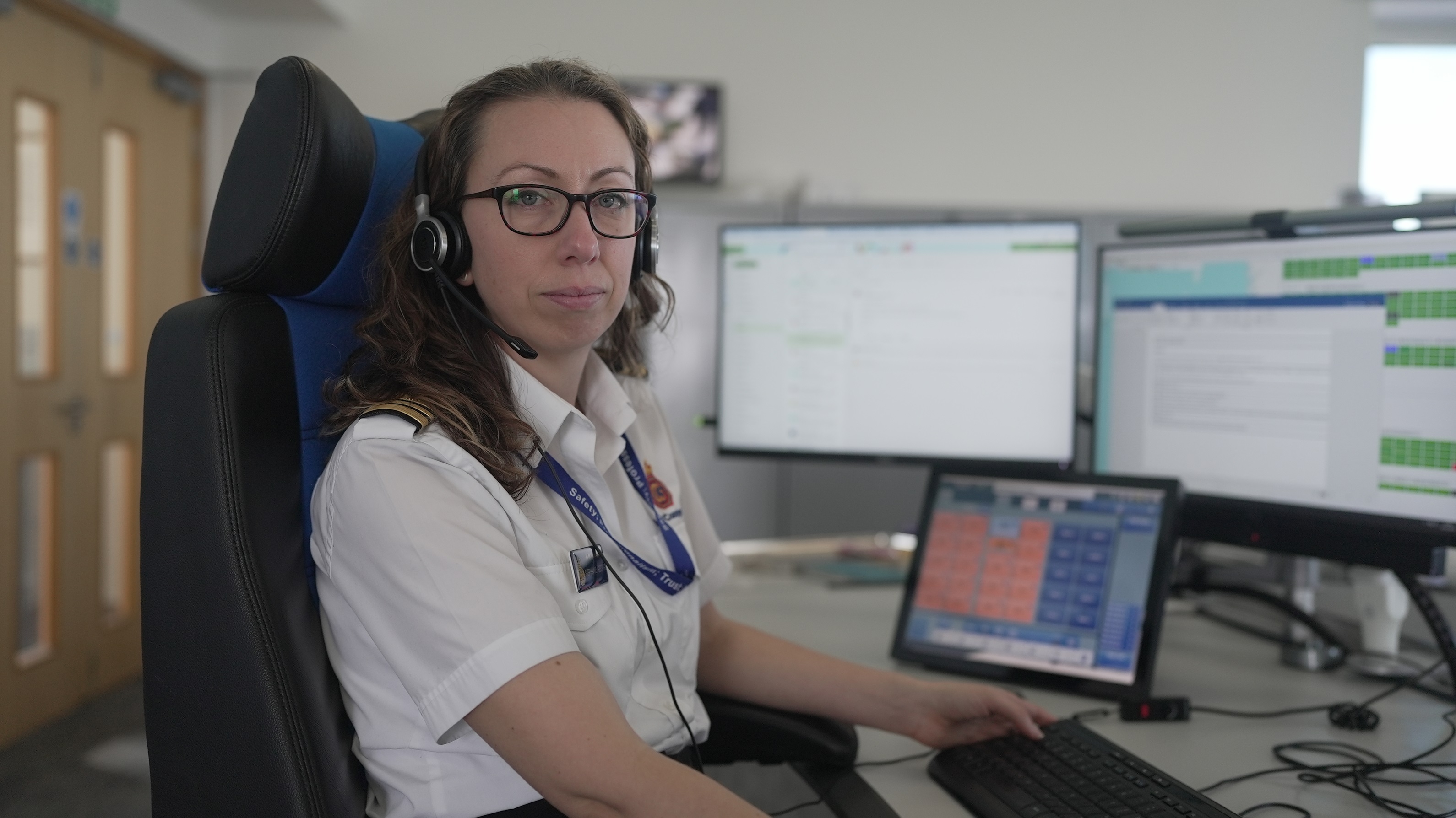 Stephanie George, Team Leader at Holyhead Maritime Rescue Coordination Centre, sits at a desk with computer screens