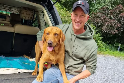 Owner Rowan with his red Labrador dog Rufus