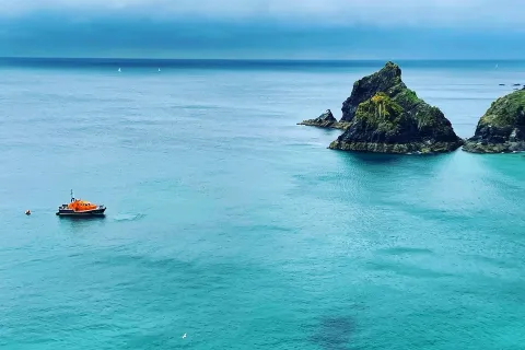 Mullion Coastguard Rescue Team and the RNLI helping when three people on a dinghy were struggling with the tide and offshore winds.