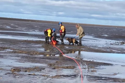 Coastguard officers involved in a mud rescue in the north west