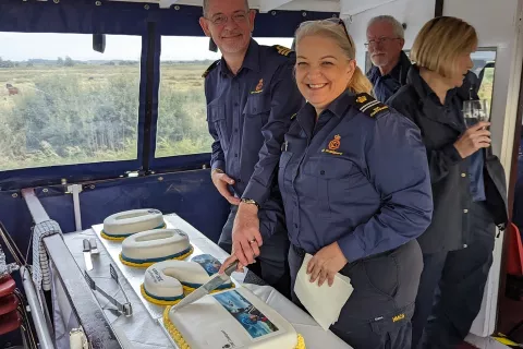 Area commander Phil Norman with cake baker Claire Hall, Station Officer at Lowestoft