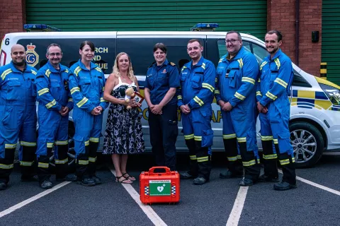Donna with one of her children, alongside HM Coastguard and ambulance staff who worked together to save her life. Credit: Yorkshire Ambulance Service