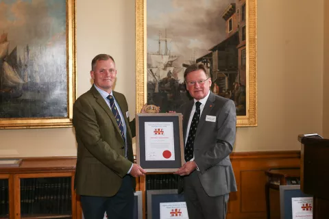 The 2022 Individual Commendation recipient at the Shipwrecked Mariners' Society annual Skill & Gallantry Awards - Mark ‘Spike’ Hughes, presented by Captain Ian McNaught, Deputy Master of Trinity House