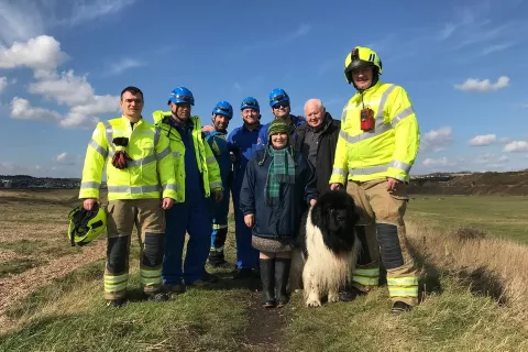 Max the Newfoundland dog with his owners and rescuers.