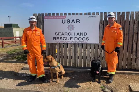 Ryan and specialist search and rescue dog Max (right) have gone to Turkey to assist in the search for survivors. Pictured here with a canine specialist colleague and his dog Delta