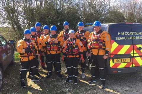 Group of Mablethorpe team members standing in their wet weather gear and blue helmets