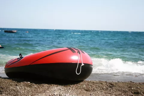 Inflatable dinghy on a beach - stock photo