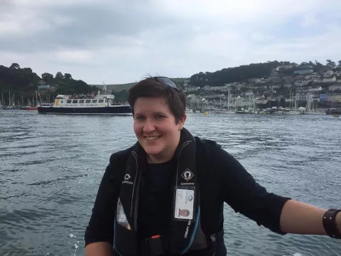 Smiling Jayne with large body of water in background and hills in distance