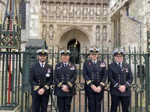 Four coastguards in dress uniform outside Westminster Abbey for remembrance events