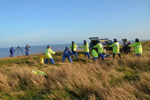 A Coastguard rope rescue team at the top of a cliff