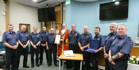 Hartlepool Coastguard Rescue Team and Ceremonial Mayor of Hartlepool Shane Moore stand for a photo, displaying the Honorary Freedom of the Borough