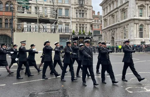 Coastguards in formal uniform marching 
