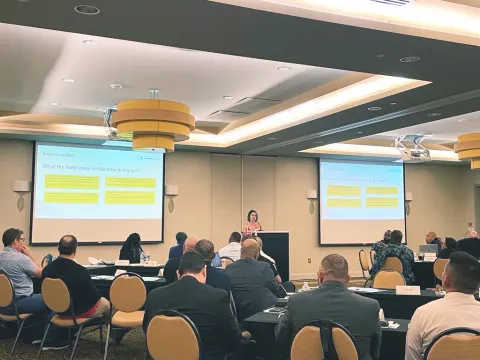 A woman gives a presentation to an audience at the SAR workshop in Miami