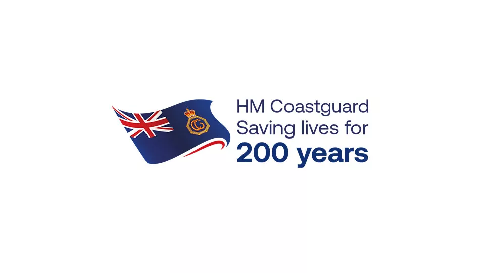 HM Coastguard flag alongside text that reads saving lives for 200 years