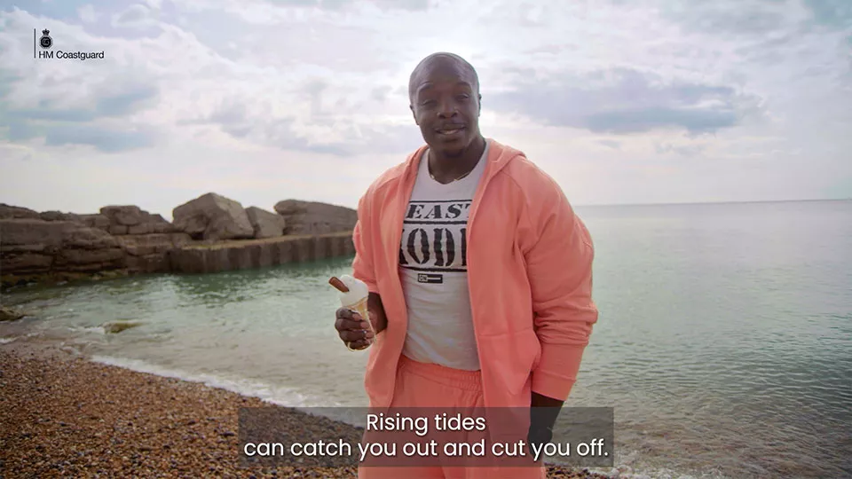 Adebayo Akinfenwa, world's 'strongest footballer', stands on a pebbled beach with an ice cream while giving tips and advice on tides