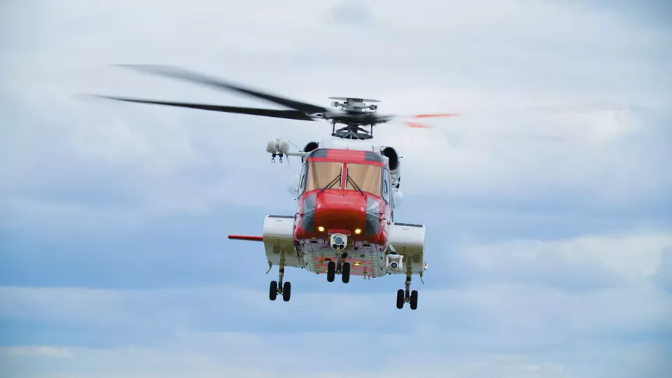 A HM Coastguard helicopter hovers in the air