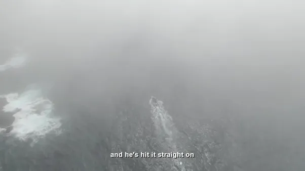 Misty sea with motor boat speeding across