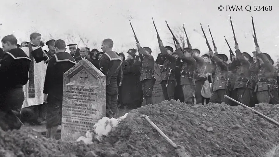 Black and white photo of soldiers at a grave