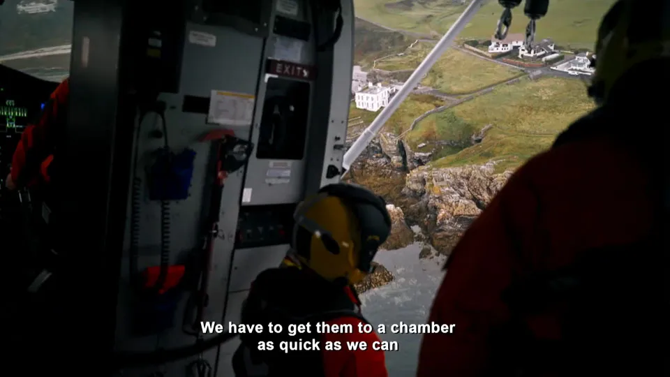 The view from an HM Coastguard search and rescue helicopter over rocky terrain