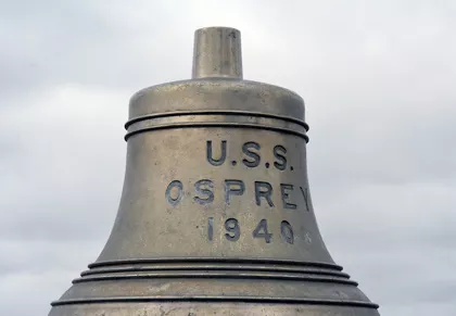 A metal bell with the words U.S.S. Osprey 1940 engraved on it