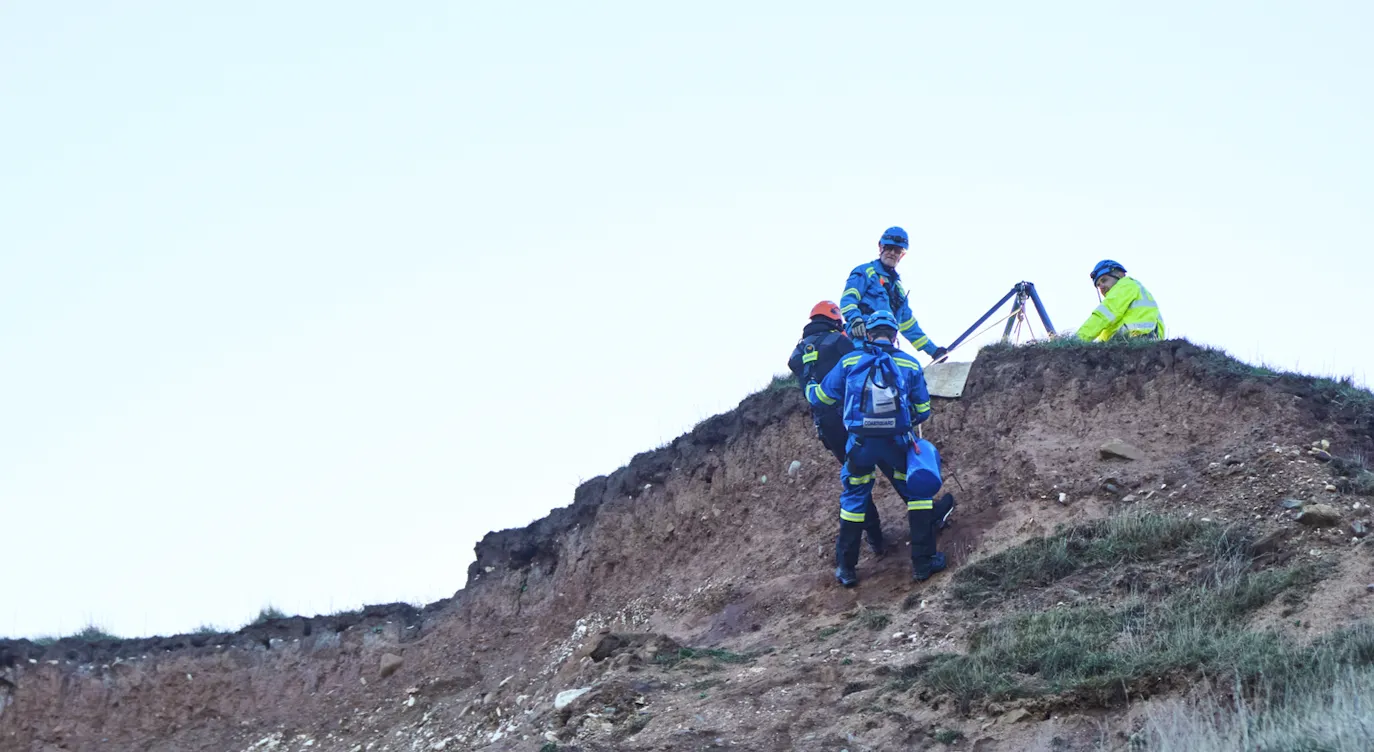 Men on cliff edge