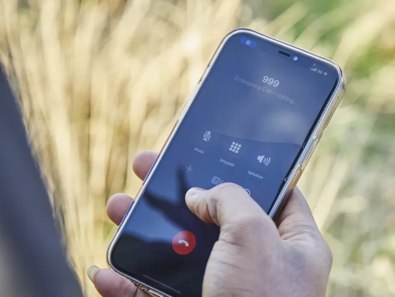 person dialling 999