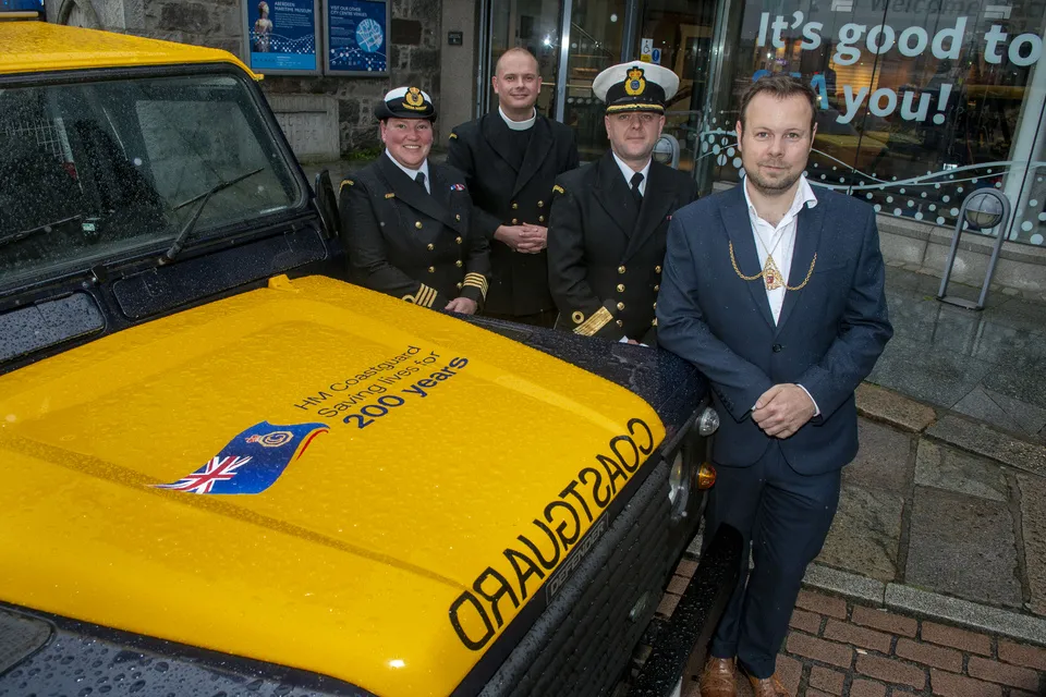 HM Coastguard volunteers and staff and dignitaries celebrating HM Coastguard's 200th anniversary