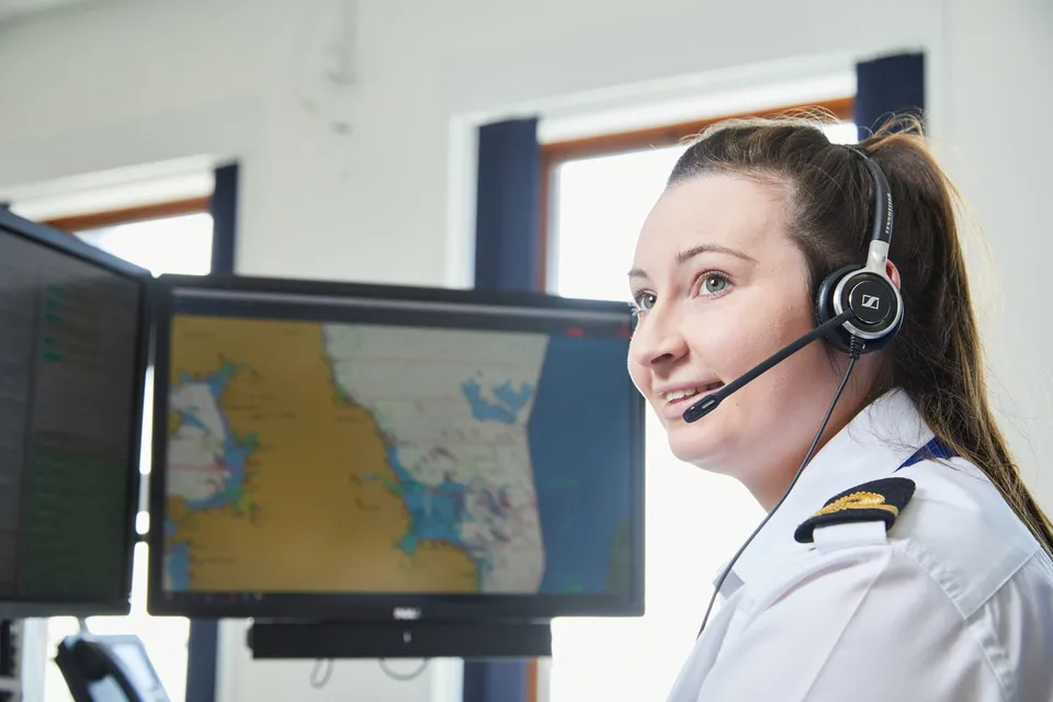 Coastguard operator sat at terminal in maritime rescue coordination centre