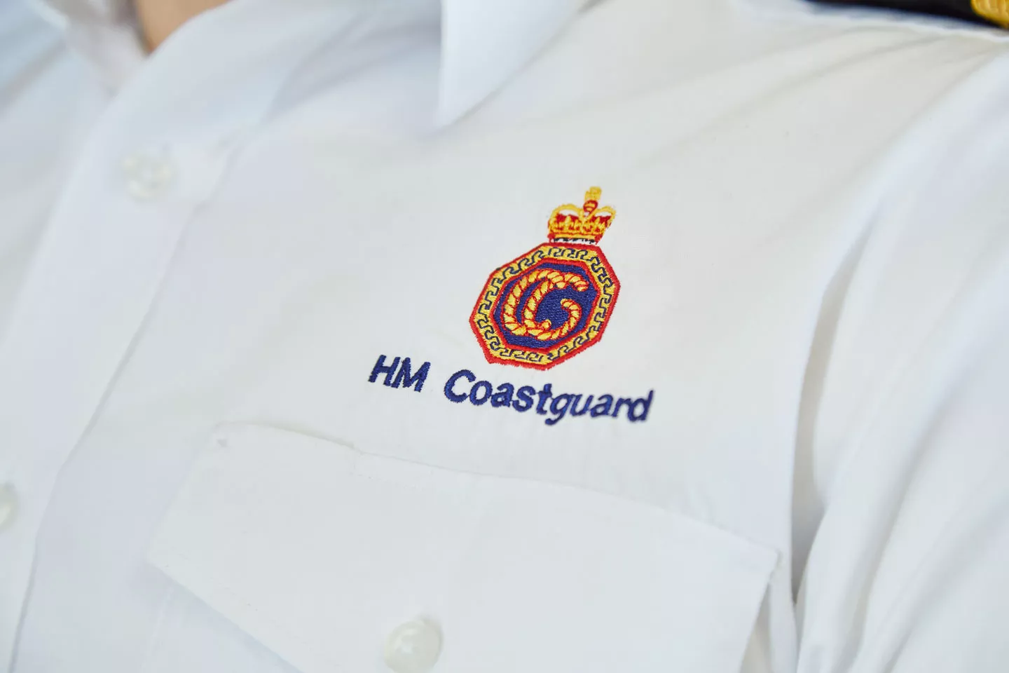 Coastguard crest on a white uniform shirt