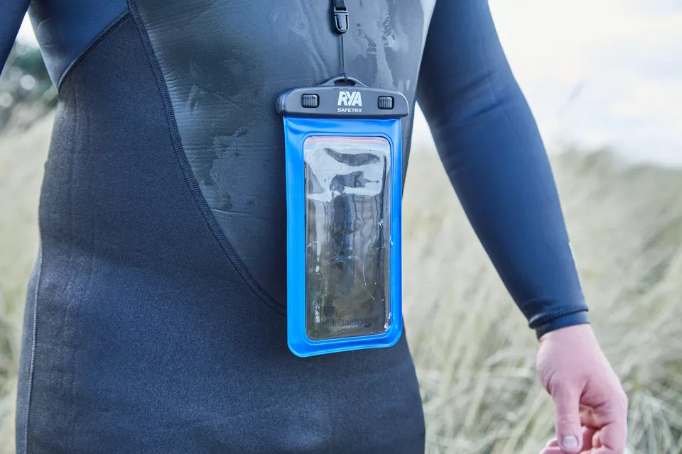 Mobile phone in a waterproof pouch hanging from lanyard around the neck of a paddle boarder wearing a wetsuit