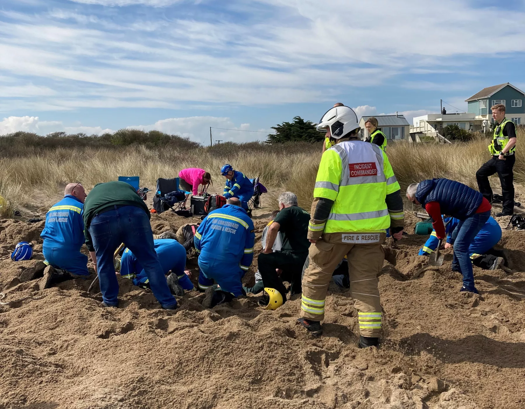 Rescuers digging out Warren Gant on the beach at Anderby Creek, Lincolnshire