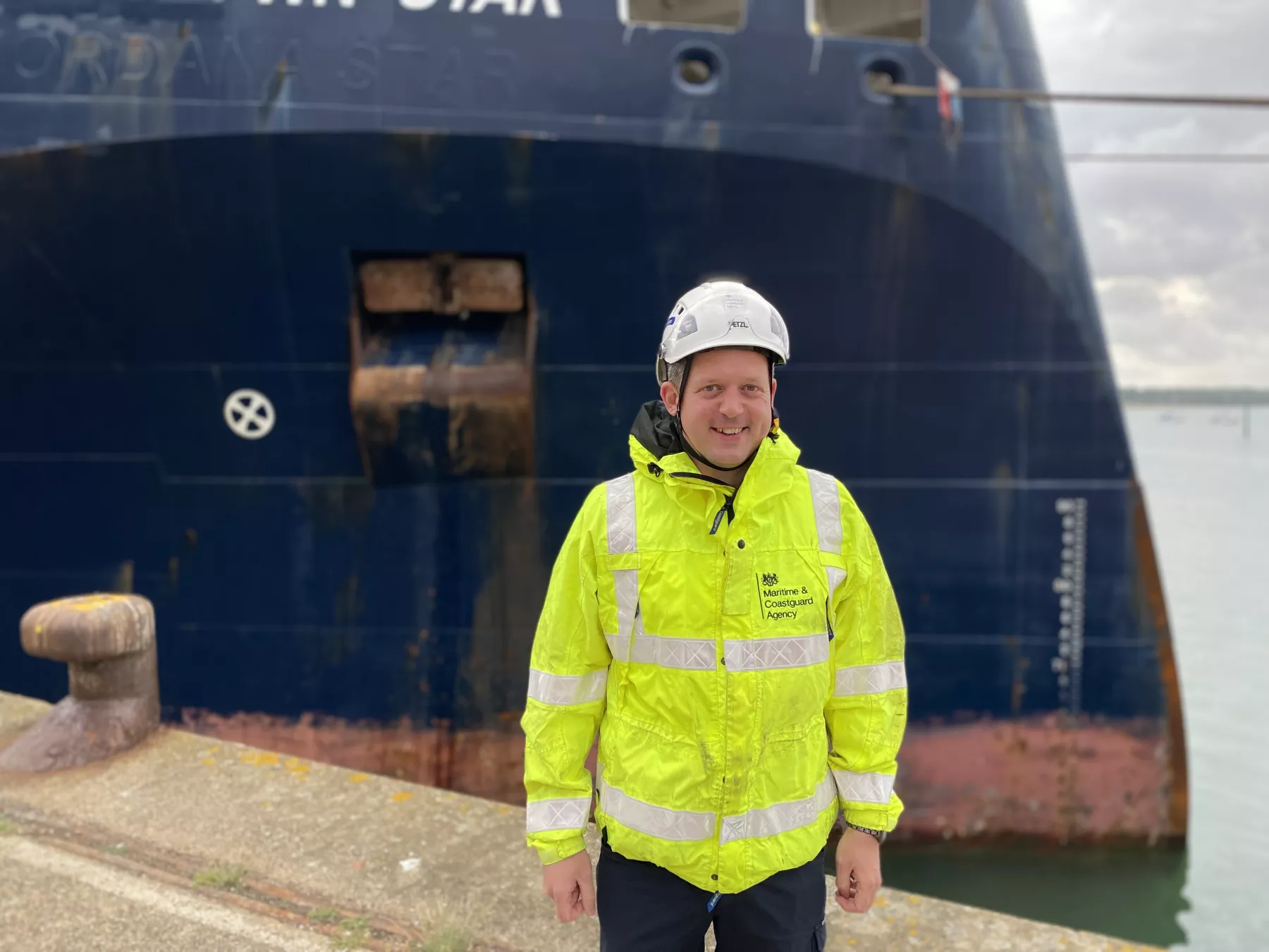 A picture of Survey and Inspection Technical Manager (Southampton) Chris D'Alcorn, stood in front of a vessel in S&I kit - Maritime Safety Week 2023