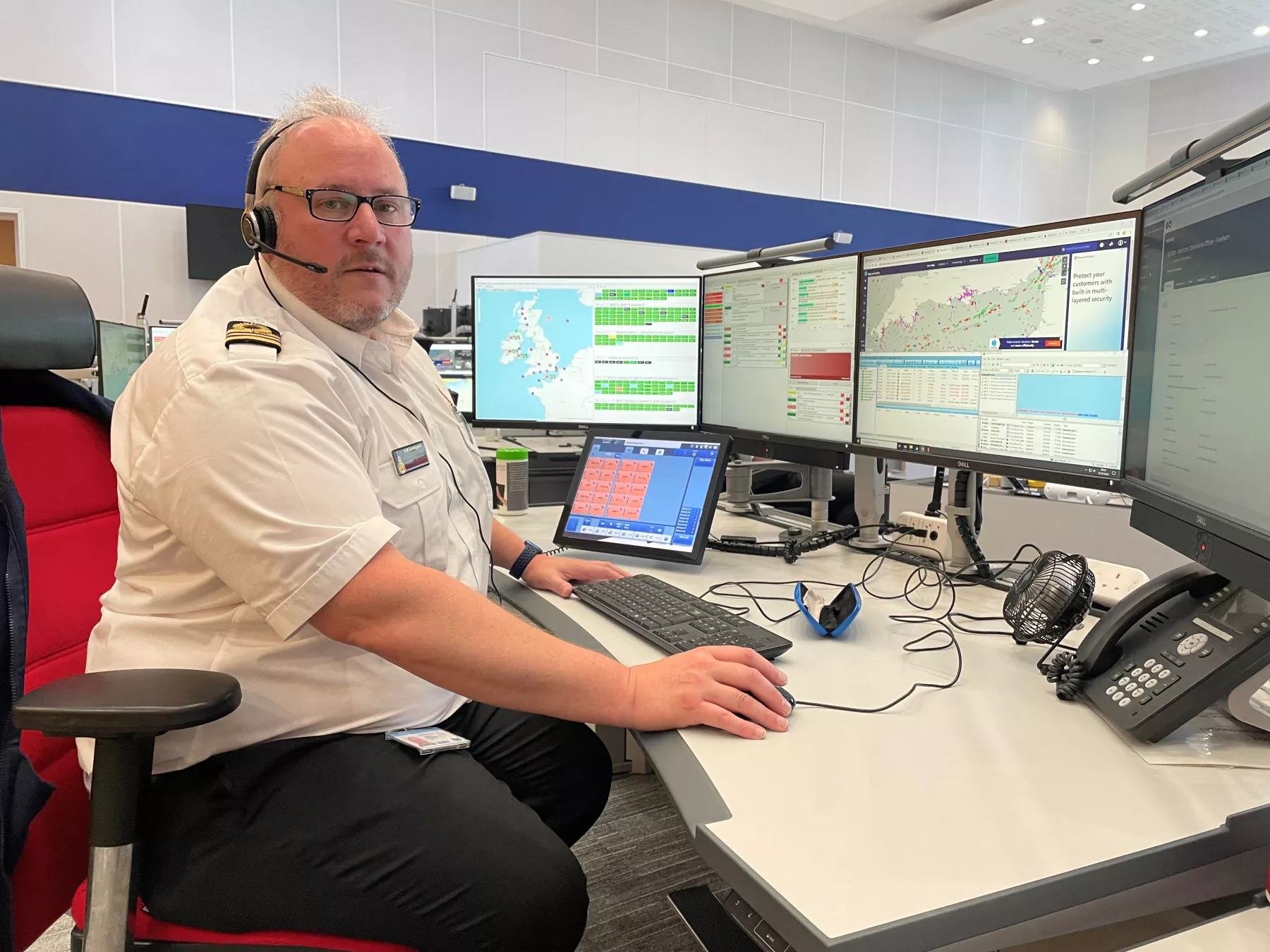 Coastguard in an operations room with headset