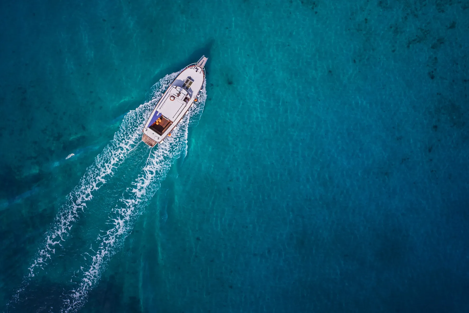 Vintage wooden boat in coral sea. Boat drone photo.