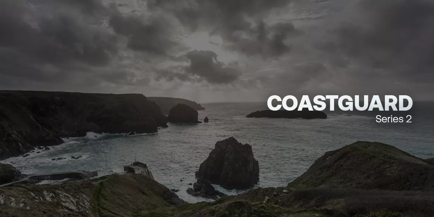 A dark and gloomy UK coastline with rocky cliffs and outcrops