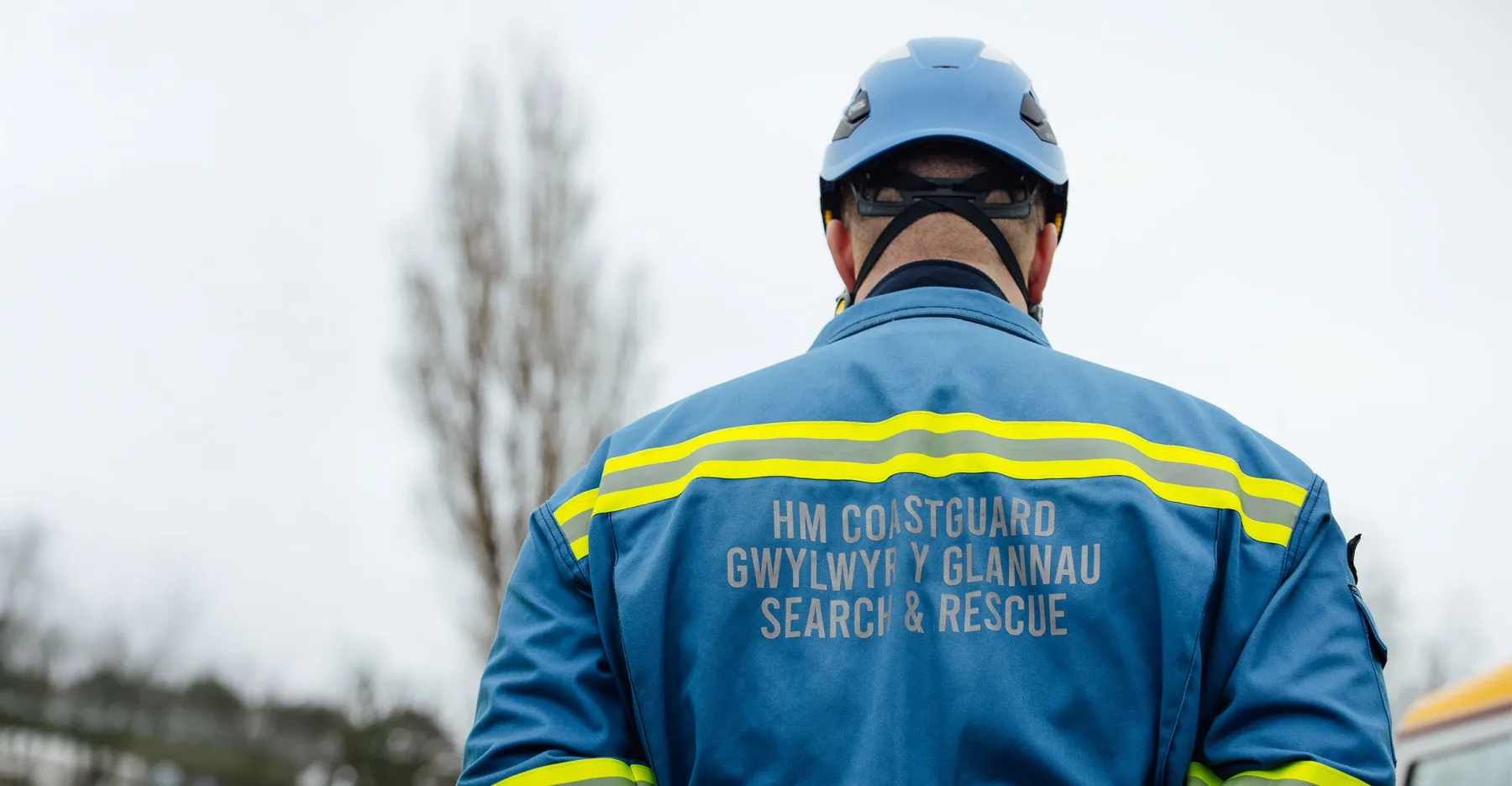 View of behind a coastguard rescue officer in overalls