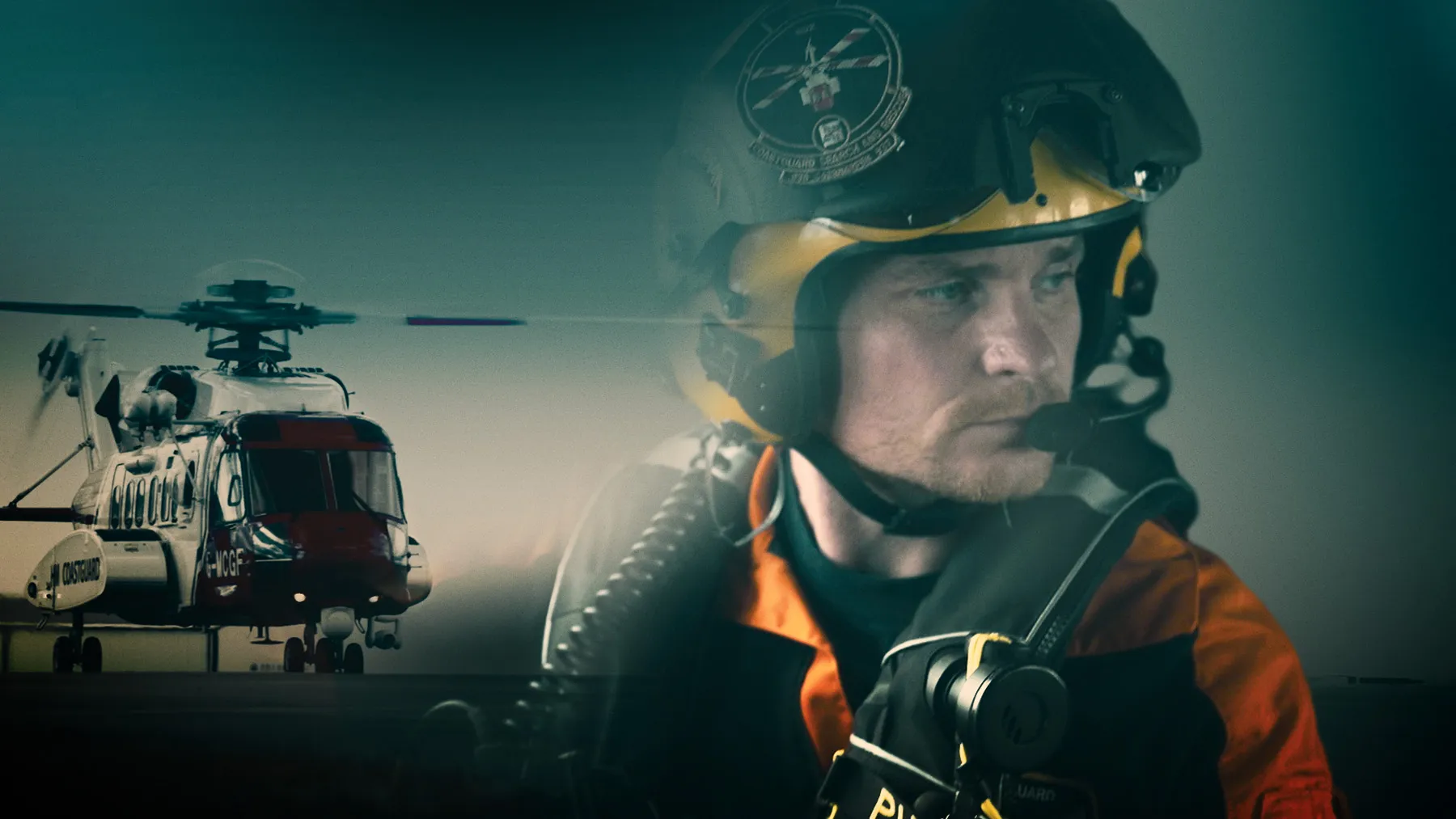 On the left, a Coastguard helicopter sits against a grey sky/. On the right, a male helicopter crew member is wearing a headset.