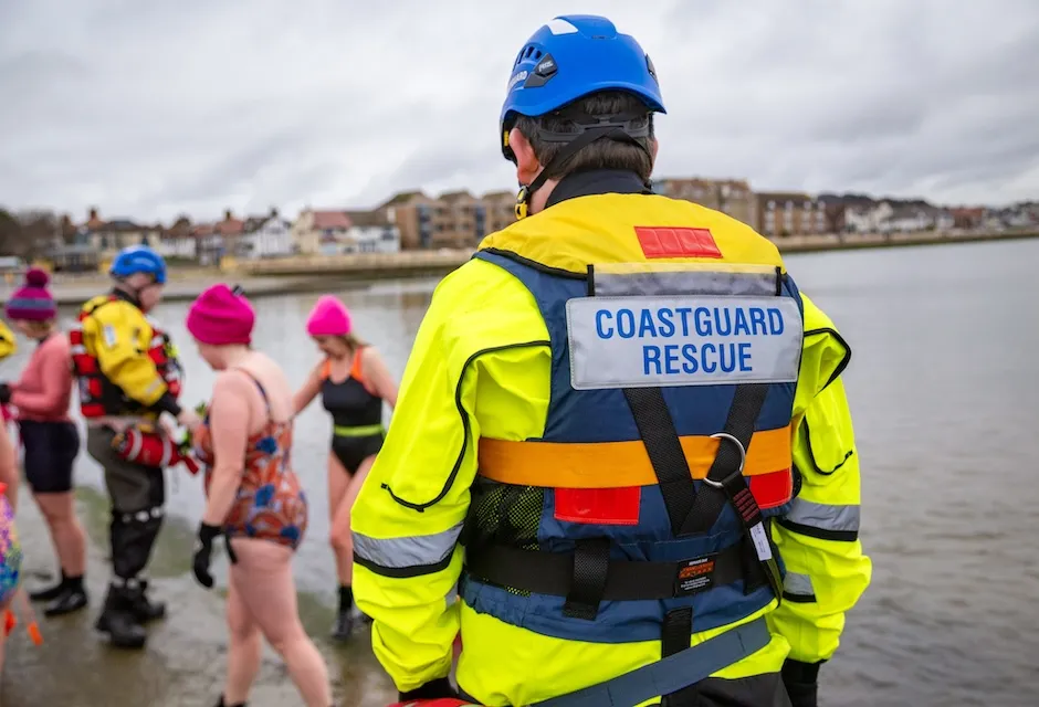 A Coastguard Rescue Officer stands by as swimmers exit waters at The Wirral