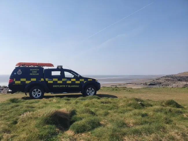 A Coastguard truck overlooking a beach.