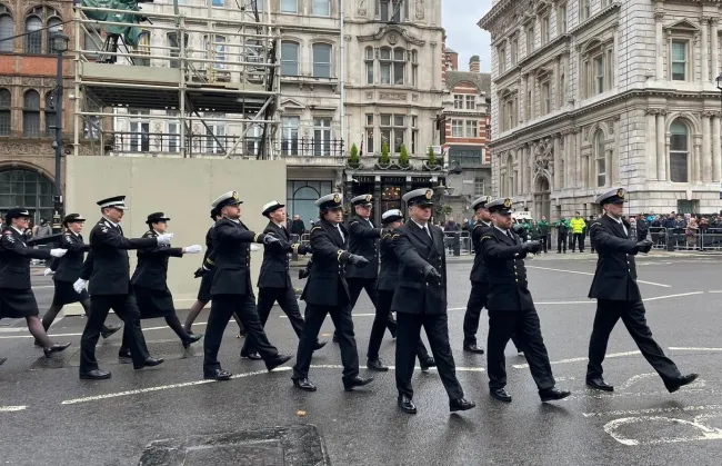 Coastguards in formal uniform marching 