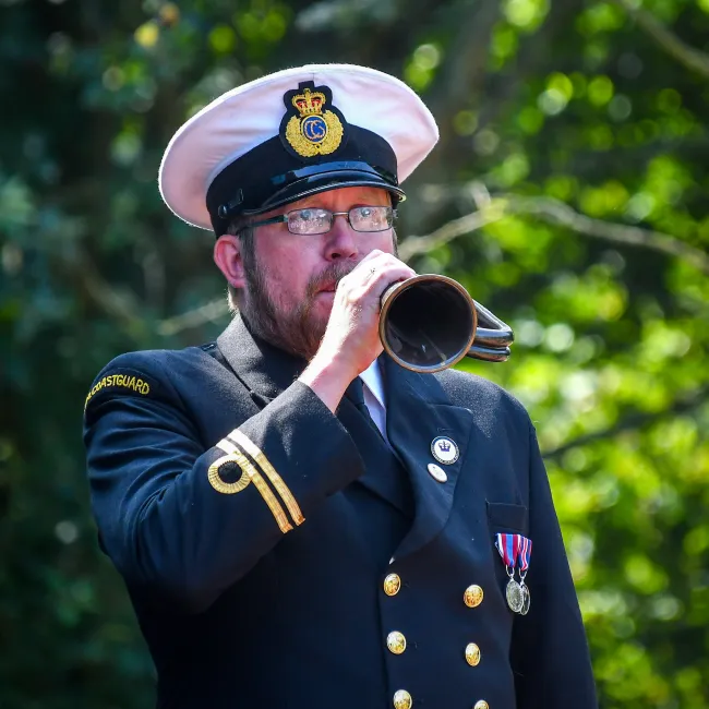Senior Maritime Operations Officer Joel Harding bugles for a Remembrance Day service