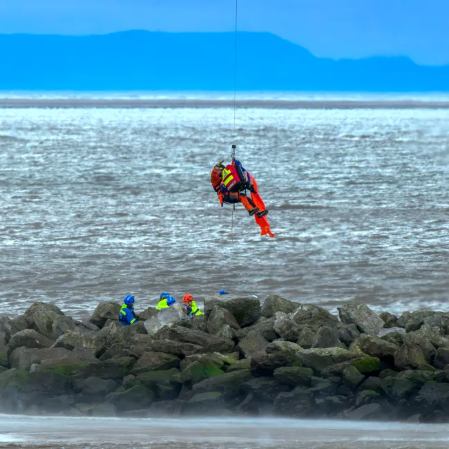 A Coastguard Winch Paramedic lifts a casualty from Leasowe Bay, Wirral