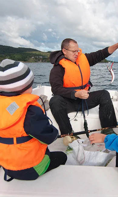 family onboard a boat fishing