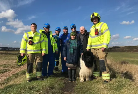 Max the Newfoundland dog with his owners and rescuers.