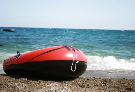 Inflatable dinghy on a beach - stock photo
